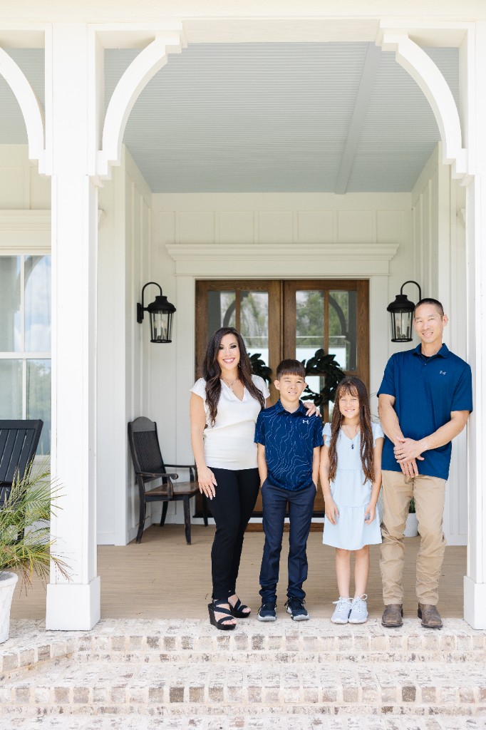 The Louie family standing together on the front porch